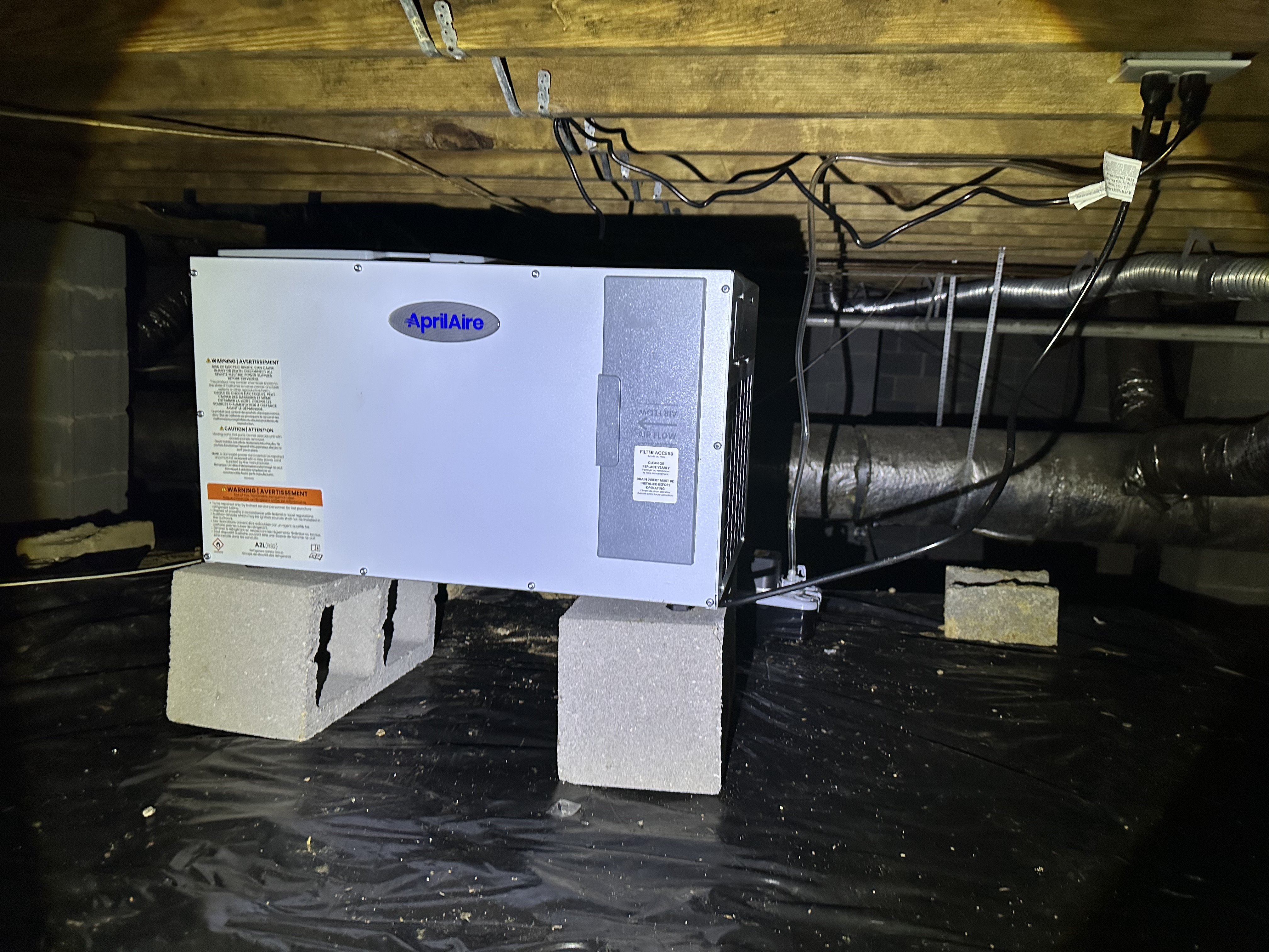 Aprilaire commercial dehumidifier installed in Asheville crawlspace with vapor barrier
